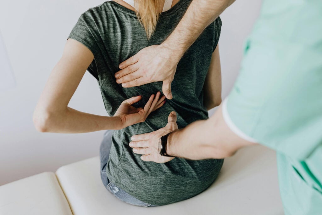 person being examined for pinched nerves from herniated disk